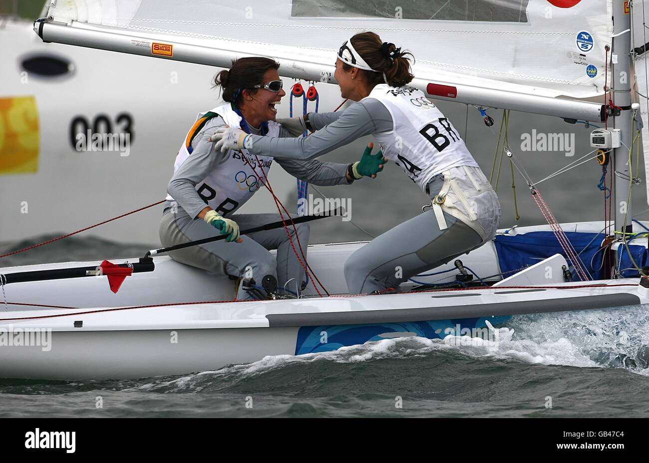 Brazil's Fernanda Oliveira and Isabel Swan celebrate after winning their final class race of the Women's 470 class during the 2008 Beijing Olympic Games' Sailing Centre in Qingdao, China. Stock Photo