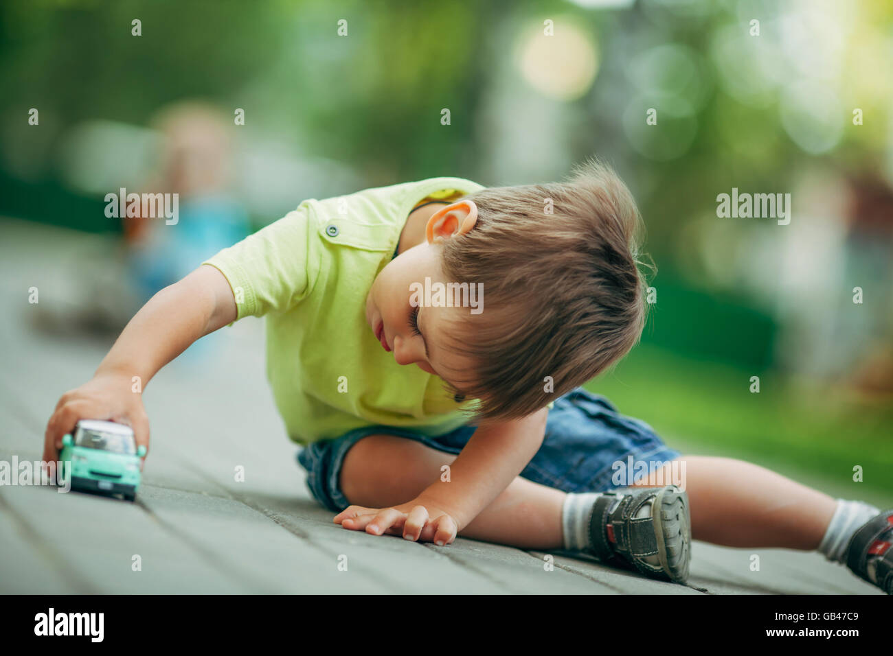 little boy playing with toy car Stock Photo - Alamy
