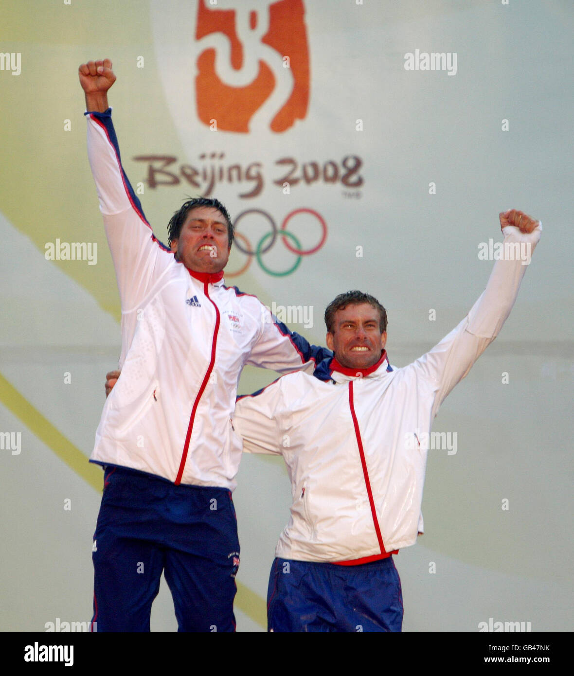 Great Britain's Star crew, Andrew Simpson (left) and Iain Percy, celebrate on the podium after winning their class at the 2008 Beijing Olympic Games' Sailing Centre in Qingdao, China. Stock Photo