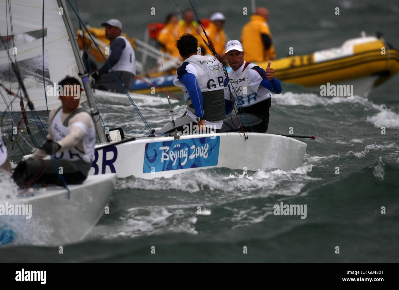 Great Britain's duo of Iain Percy and Andrew Simpson signal their Gold Medal success in the Star class at the 2008 Beijing Olympic Games Sailing Centre in Qingdao, China. Stock Photo
