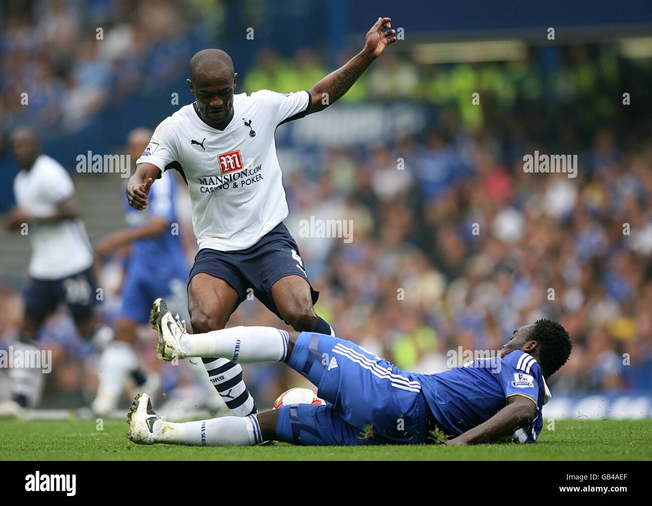 Soccer - Barclays Premier League - Chelsea v Tottenham Hotspur - Stamford Bridge. Chelsea's Michael Essien (right) slides in to challenge Tottenham Hotspur's Didier Zokora. Stock Photo