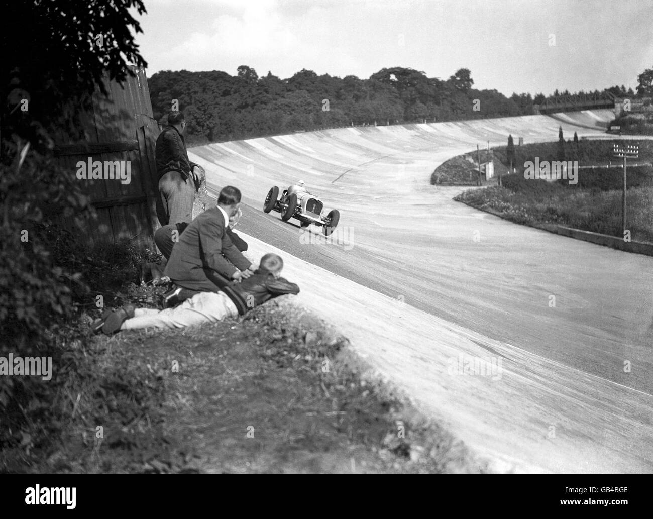 Enthusiasts watching the race from the edge of the banking as John Cobb hurtles towards them in his Napier Railton. Stock Photo