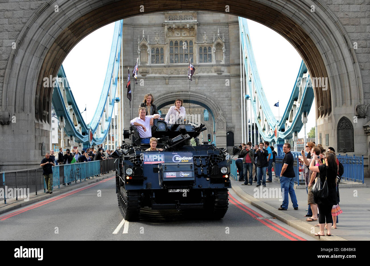Top Gear presenters, (l-r) Jeremy Clarkson, James May and Richard Hammond, are driven across Tower Bridge in a stretched (two welded together) 434 Armoured Personel Carrier, to a Press Conference in Tower Hotel, to launch Top Gear going live (with debut at the MPH Prestige and Performance Motor Show, Earls Court in October), St Katherines Way, London. Stock Photo