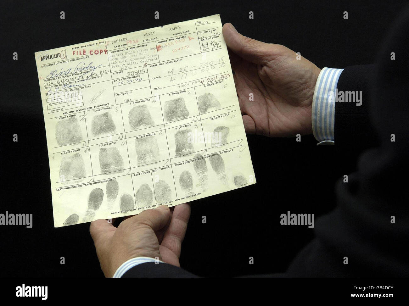 A person holds Elvis Presley's Concealed Weapon application which has Elvis's fingerprints on it, at London's Idea Generation Gallery. Stock Photo