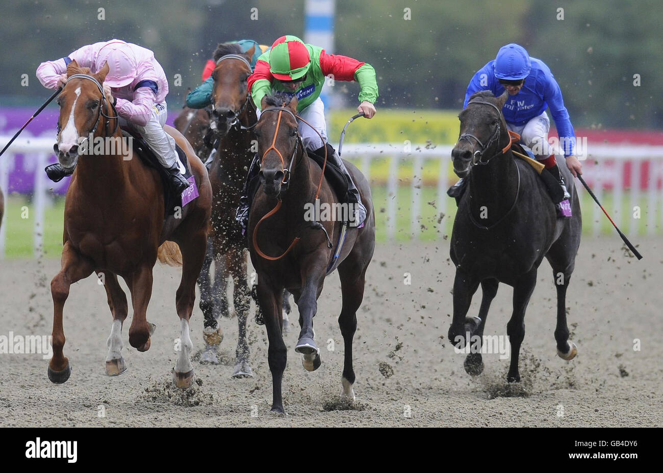 Elnawin and jockey Pat Dobbs (centre) win The toteswinger Sirenia Stakes from Square Eddie and Steve Drowne (left) at Kempton Park Racecourse, Middlesex. Stock Photo