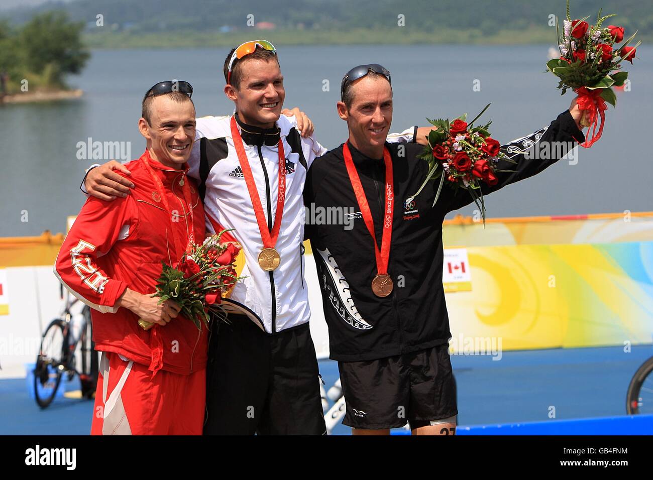 Germany's Jan Frodeno with his gold medal (centre), Canada's Simon Whitfield with his silver medal (left), and New Zealand's Bevan Docherty with his bronze medal in the Men's Triathlon at the Triathlon Venue in Beijing during the 2008 Beijing Olympic Games. Stock Photo