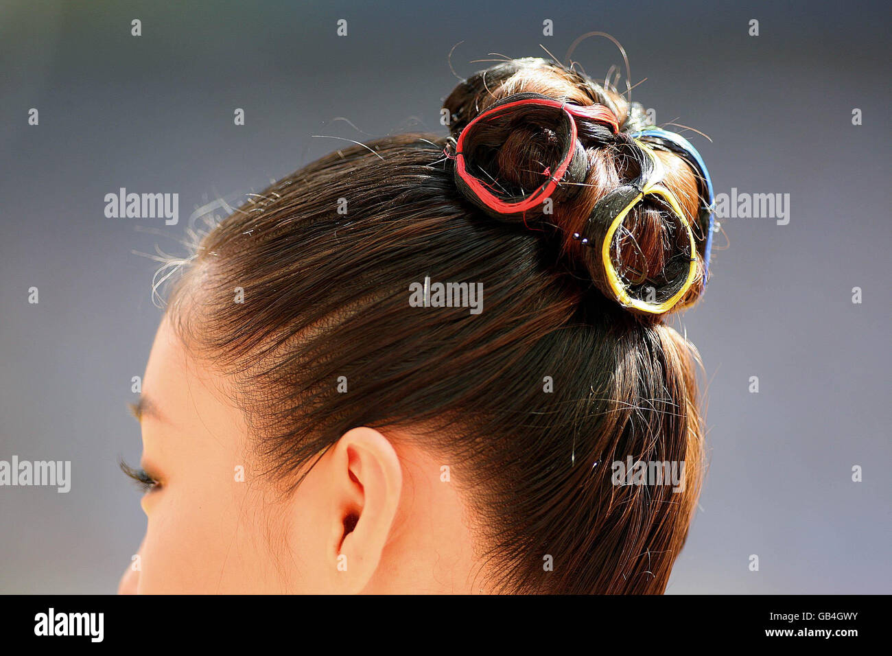 One of the medal presenters has her hair tied up in the colours of the Paralympic Games at the National Stadium during the Beijing Paralympic Games 2008, China. Stock Photo