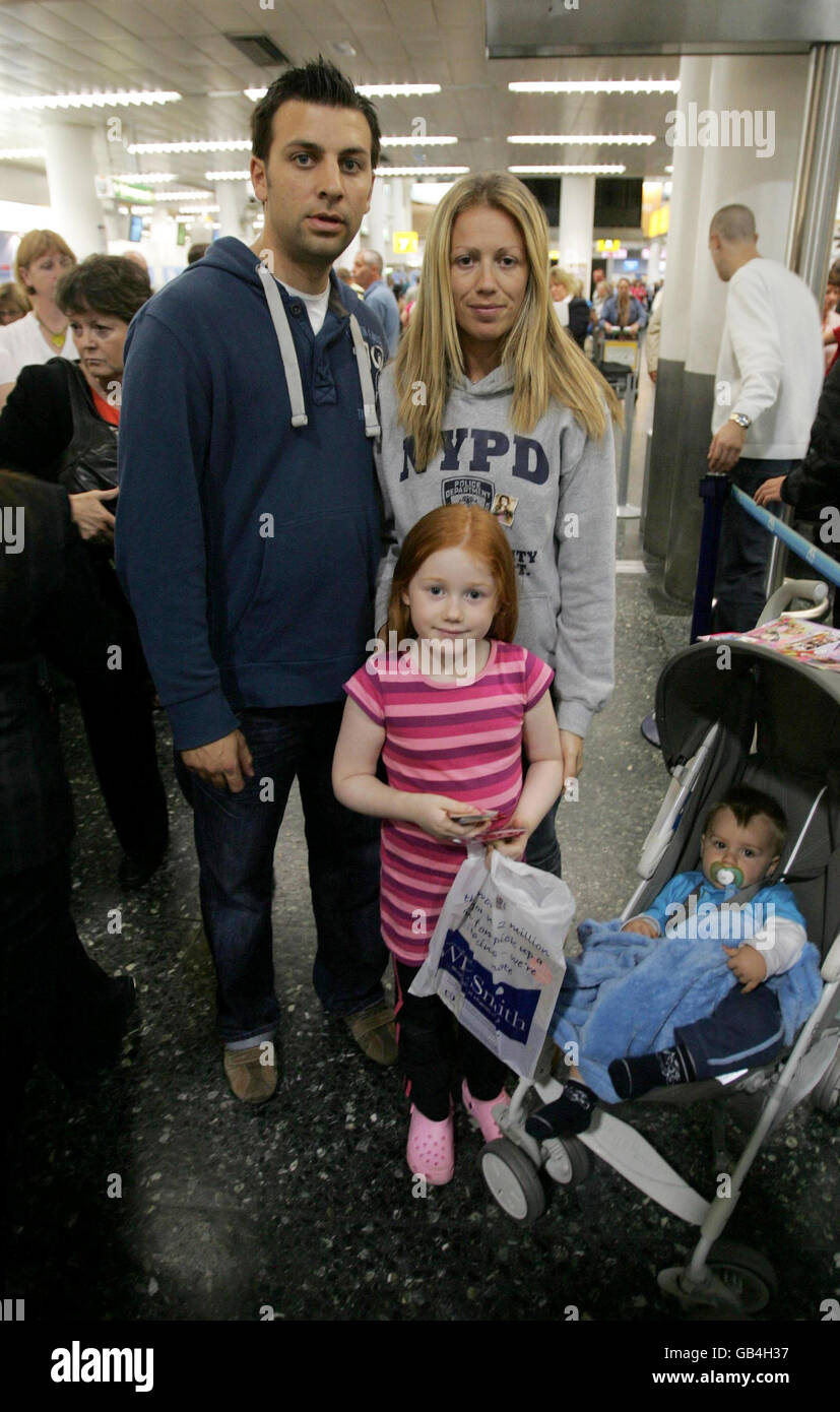 Honeymoon couple Mark and Kelly Belcher, from Southend-on-Sea in Essex and who were married only last weekend, are stranded at Gatwick Airport with their children Zoe (front) and Samuel (front right). The family were hoping to fly out to Sciathyos, Greece, this morning with XL. Stock Photo