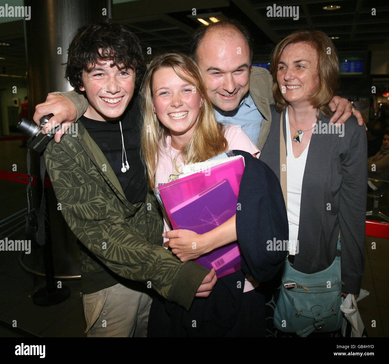 Holly Byrne, one among twenty trainees and five crew were rescued from life rafts by the French coastguard after the Asgard II went down 20 nautical miles off the coast of France in the Bay of Biscay, is welcomed back to Dublin airport by her brother Glen, father Larry and mother Maria. Stock Photo