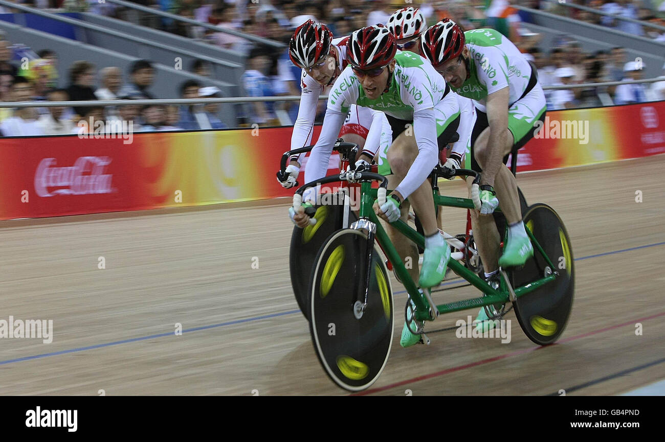 Irish cyclists David Peelo (left) and Michael Delaney compete in the Mens Sprint B&VI (1-3) with Canada closing in behind them in the Laoshan Velodrome at the Beijing Paralympic Games 2008, China. Stock Photo