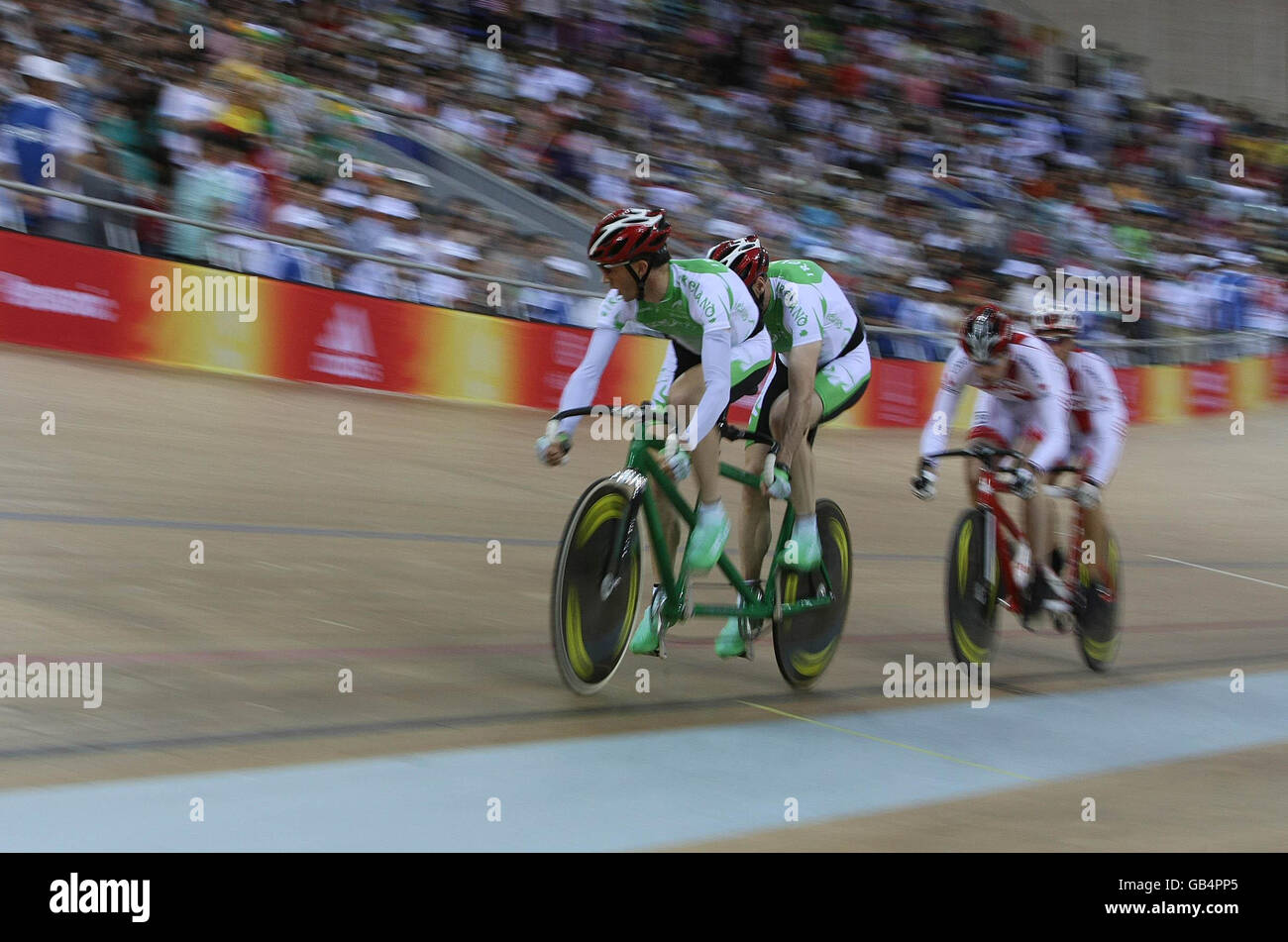Irish cyclists David Peelo and Michael Delaney competiting in the Mens Sprint B&VI (1-3) with Canada closing in behind in the Laoshan Velodrome at the Beijing Paralympic Games 2008, China. Stock Photo