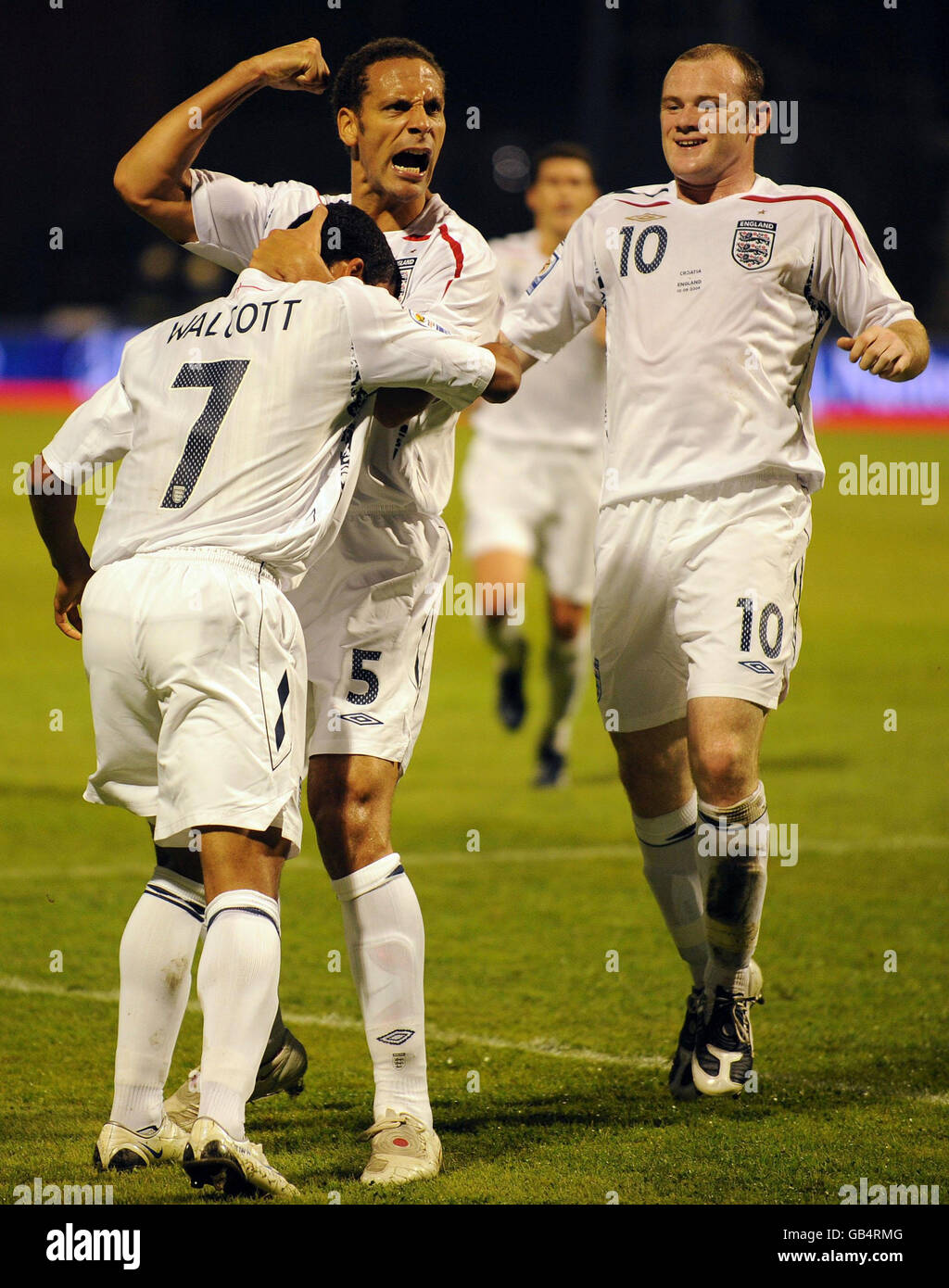 England's Theo Walcott (left) celebrates with Rio Ferdinand and Wayne Rooney after scoring during the World Cup Qualifying Group Six match at the Stadion Maksimirl, Zagreb, Croatia. Stock Photo