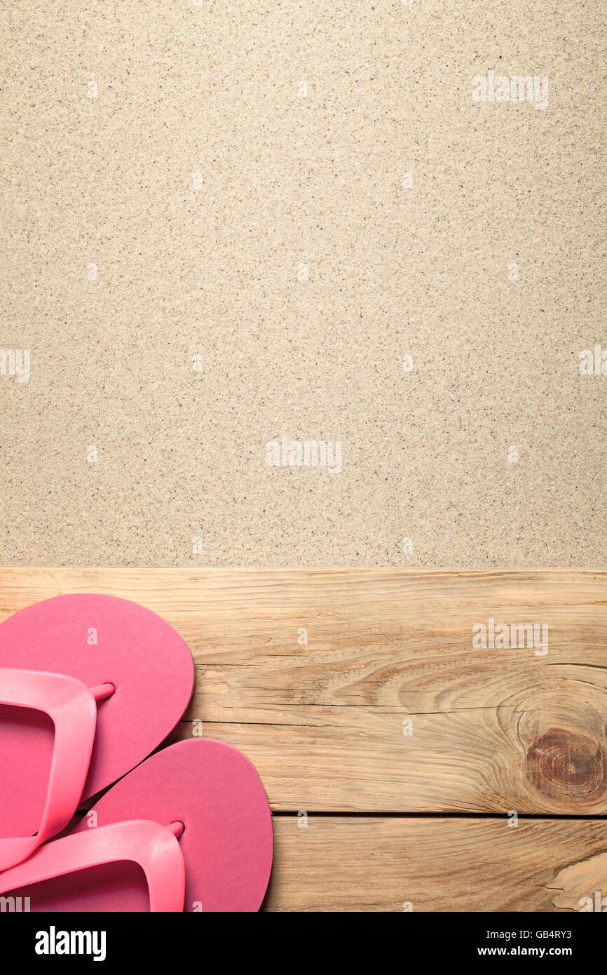 Summer background with pink flip flops on sandy beach Stock Photo - Alamy
