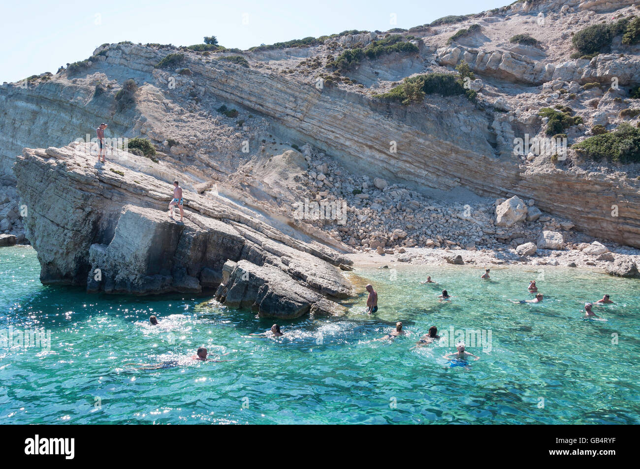 'Three island excursion' tourists swimming off boat on island of Pláti, The Dodecanese, South Aegean Region, Greece Stock Photo