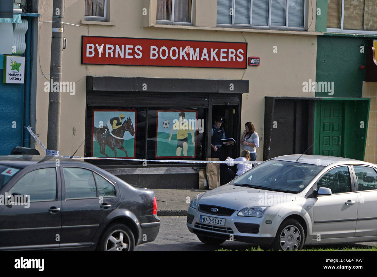 Gardai at the scene where a man was shot dead in a bookmakers shop on ...