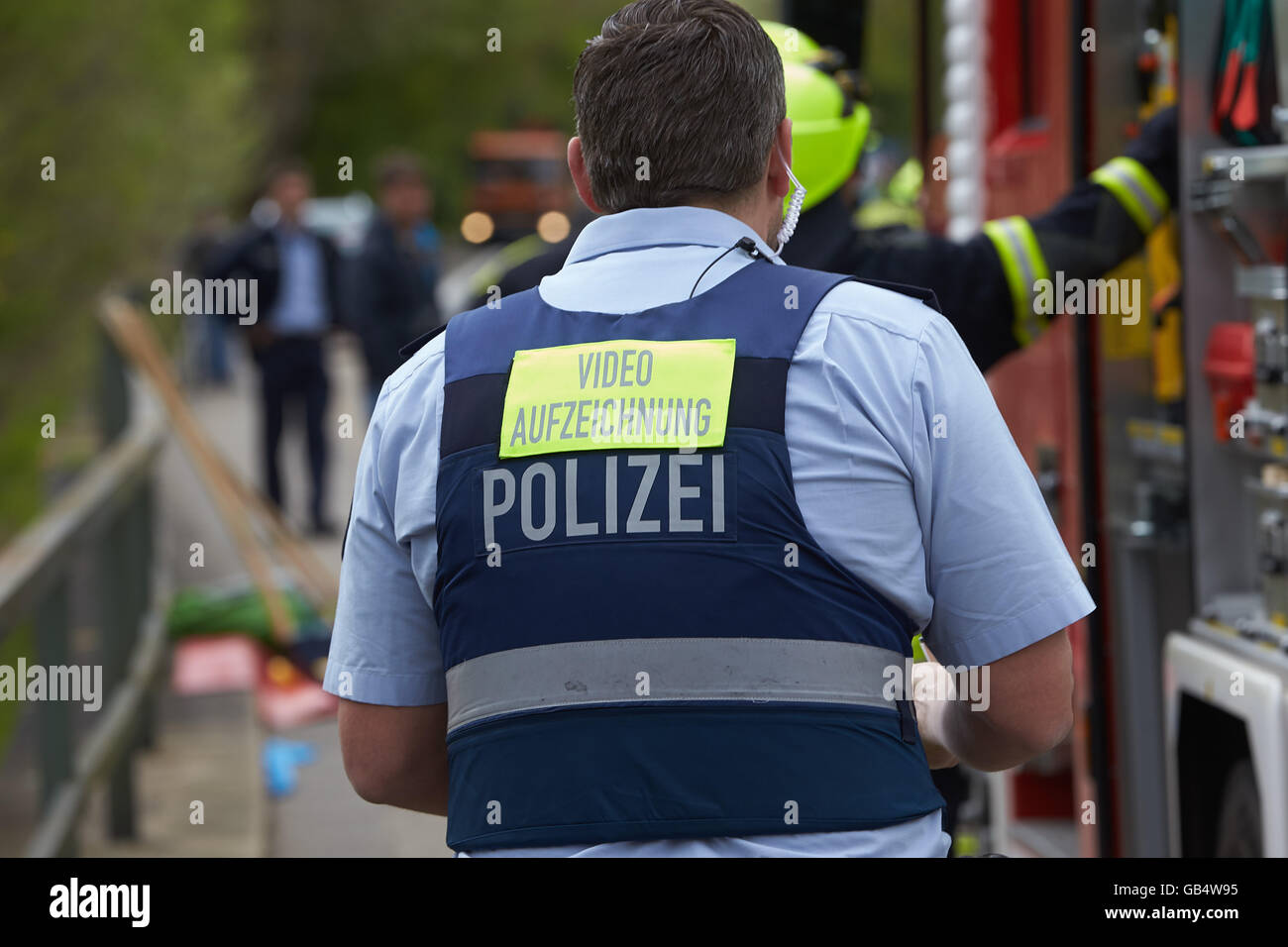 Police officer with sign on hois back, video recording, traffic accident, Germany Stock Photo