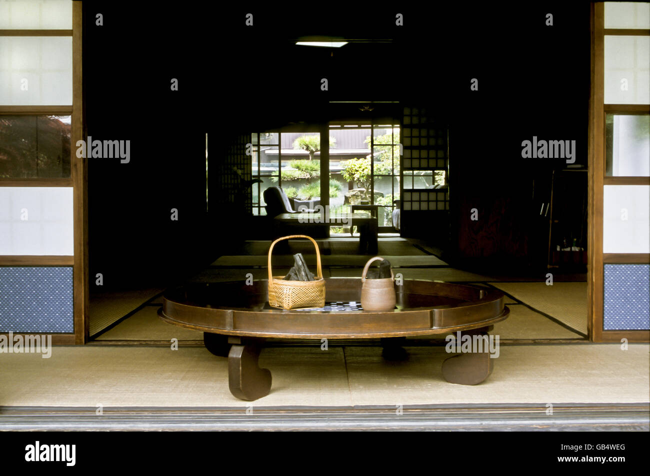 Round table with bambu basket and binchotan charcoal, private house, Japan, Asia Stock Photo