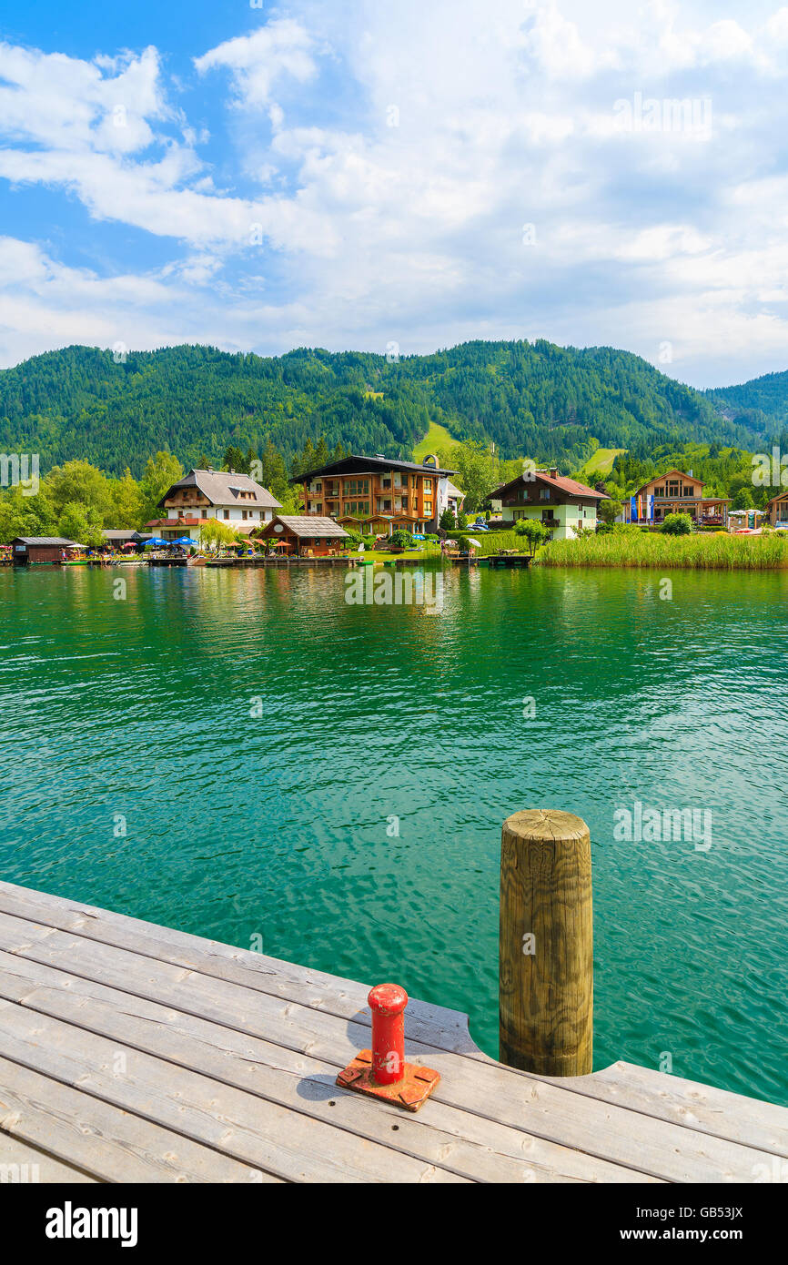 Wooden pier on green water Weissensee lake in Alps Mountains, Austria Stock Photo
