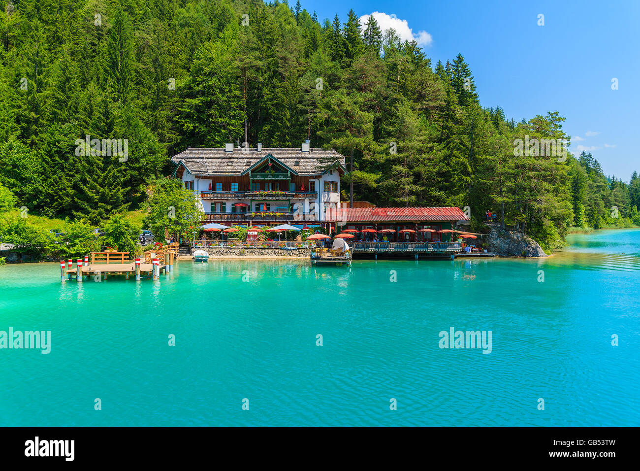 WEISSENSEE LAKE, AUSTRIA - JUL 7, 2015: restaurant and guest house on shore of Weissensee lake in summer time. Weissensee has dr Stock Photo