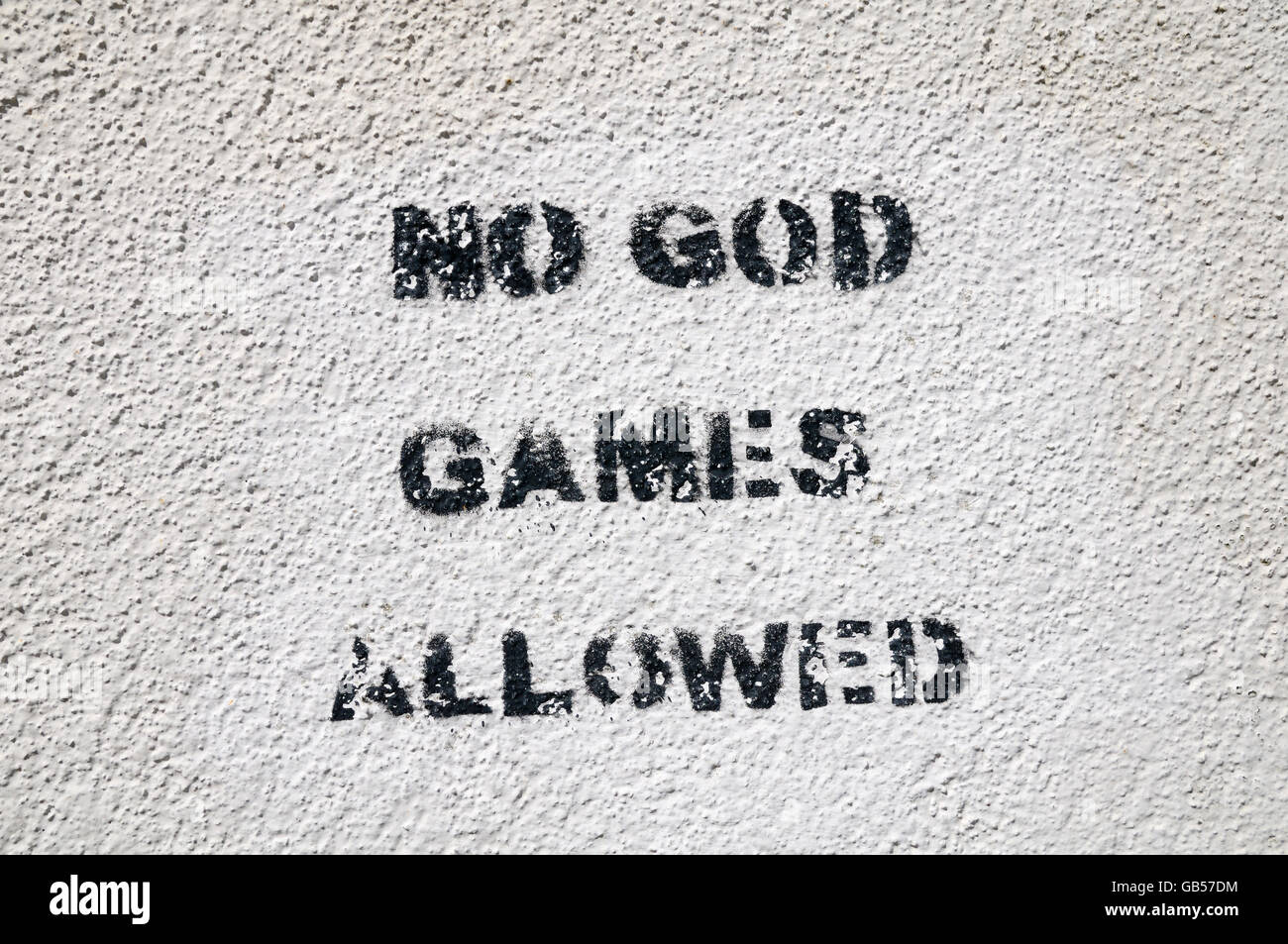 Stencil graffiti on a wall 'NO GOD GAMES ALLOWED' Stock Photo