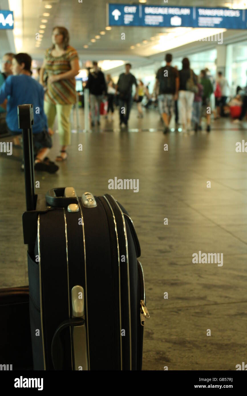 Suitcase at airport terminal Stock Photo Alamy