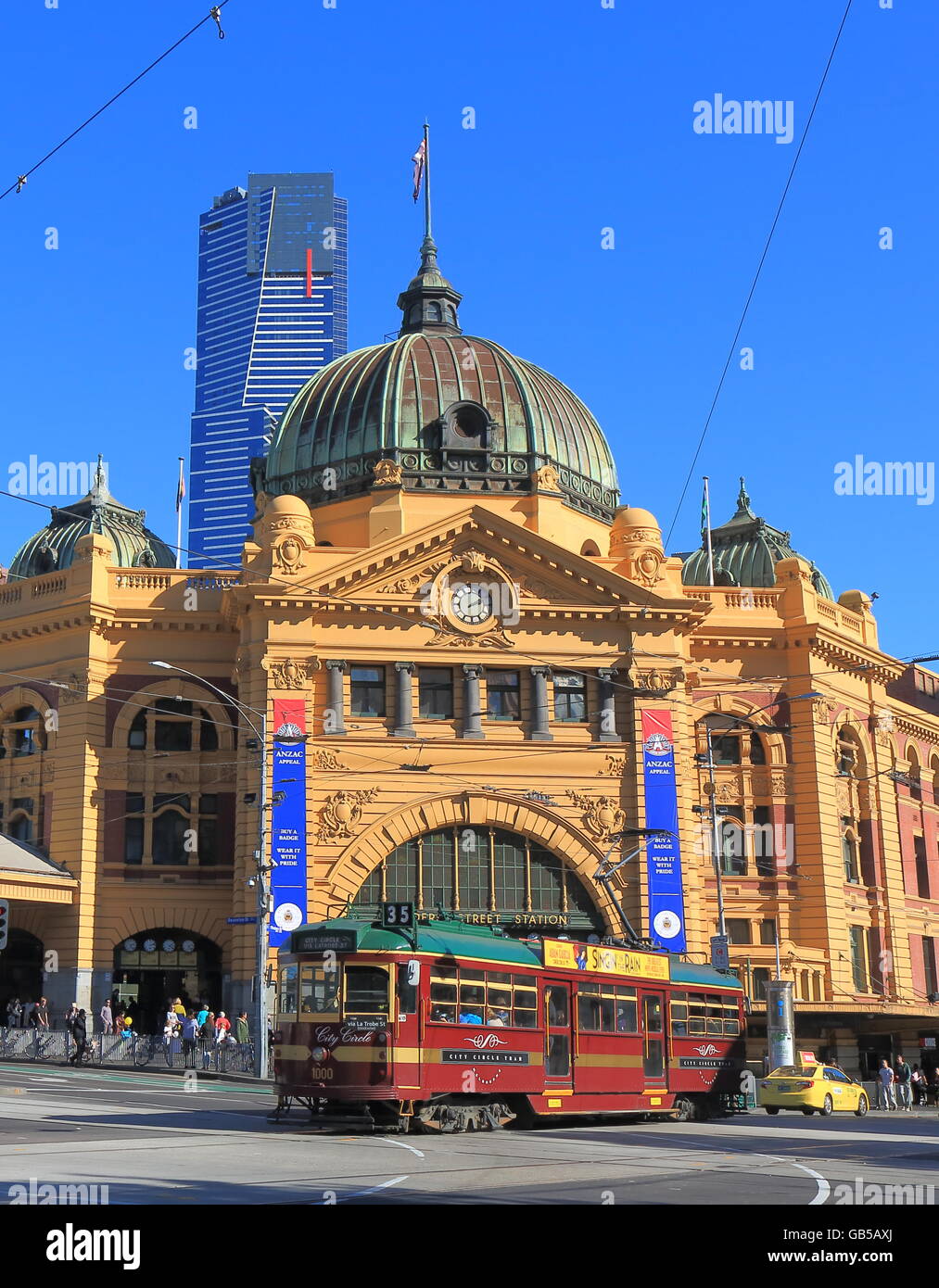 Iconic tram runs in front of Flinders Street Station in Melbourne Australia Stock Photo