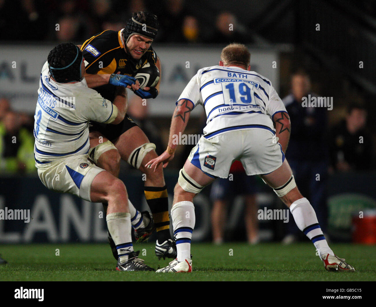 Bath Rugby's Matt Stevens (l) and James Scaysbrook (r) combine to bring down London Wasps' Tom Palmer Stock Photo