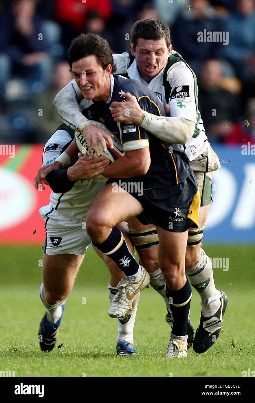 Worcester's Jonny Arr is tackled by London Irish's Declan Danaher during the EDF Energy Cup at Sixways Stadium, Worcester. Stock Photo