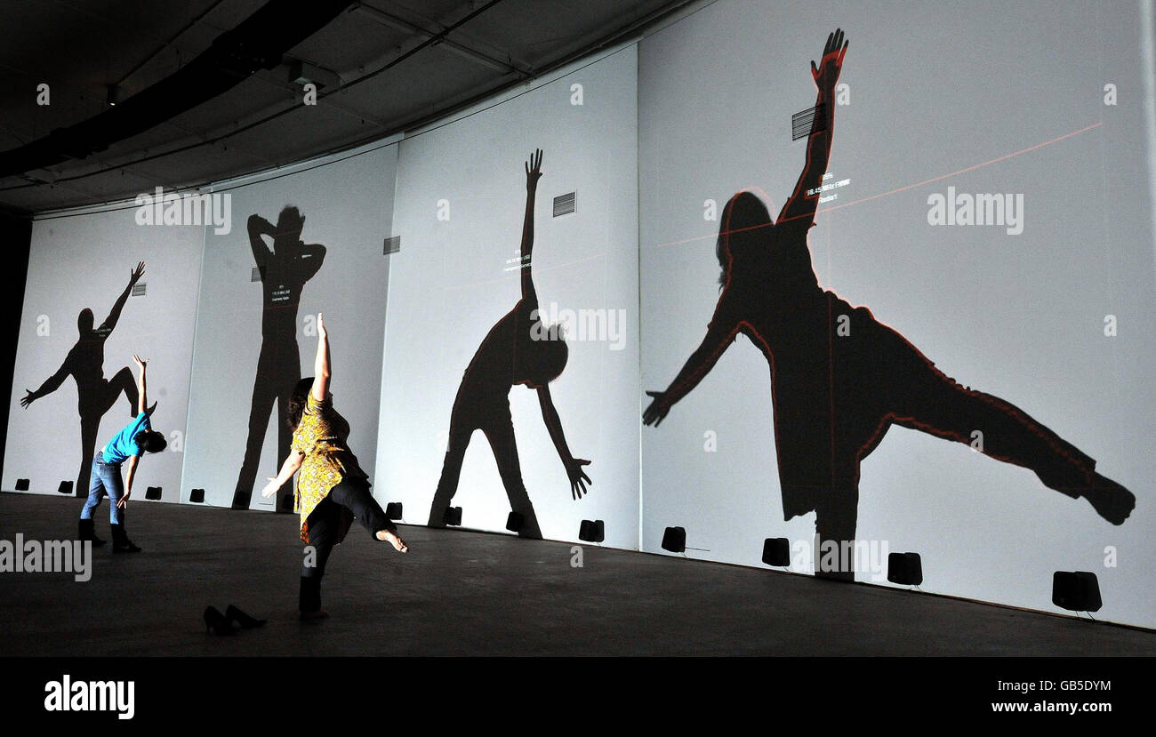 A group of four women try the new Frequency and Volume art installation, by Rafael Lozano-Hemmer in The Curve Gallery at the Barbican, London. Stock Photo