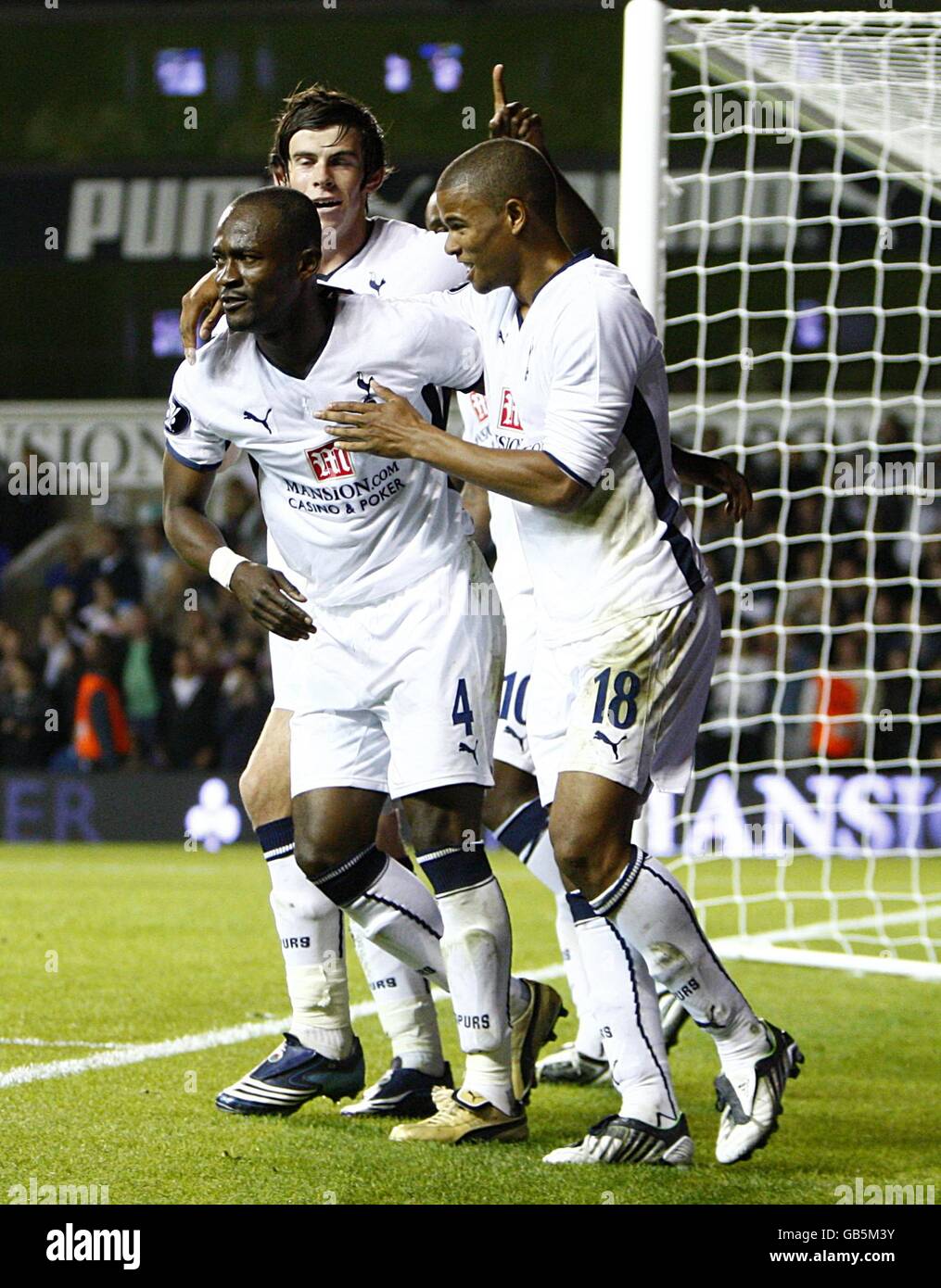 Tottenham Hotspur's Didier Zokora (l) and Gareth Bale (back) congratulate team mate Fraizer Campbell (r) after he supplies the ball for for Darren Bent (not pictured) to head home his side's second goal of the night Stock Photo