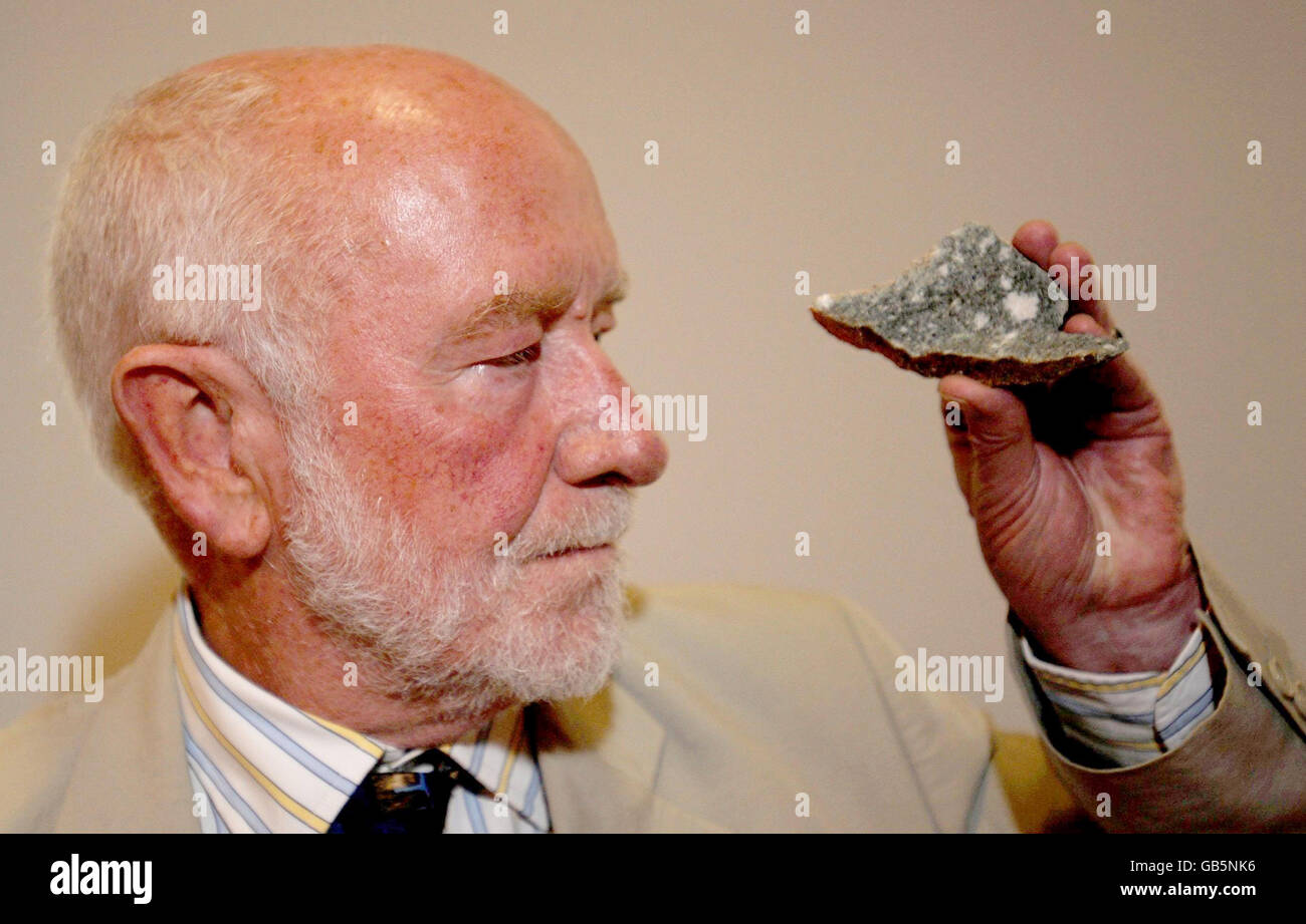 Professor Geoffrey Wainwright, President of the Society of Antiquaries of London, holds a piece of bluestone taken from the Preseli Hills, in west Wales, during a news conference in London following an excavation at Stonehenge. Stock Photo