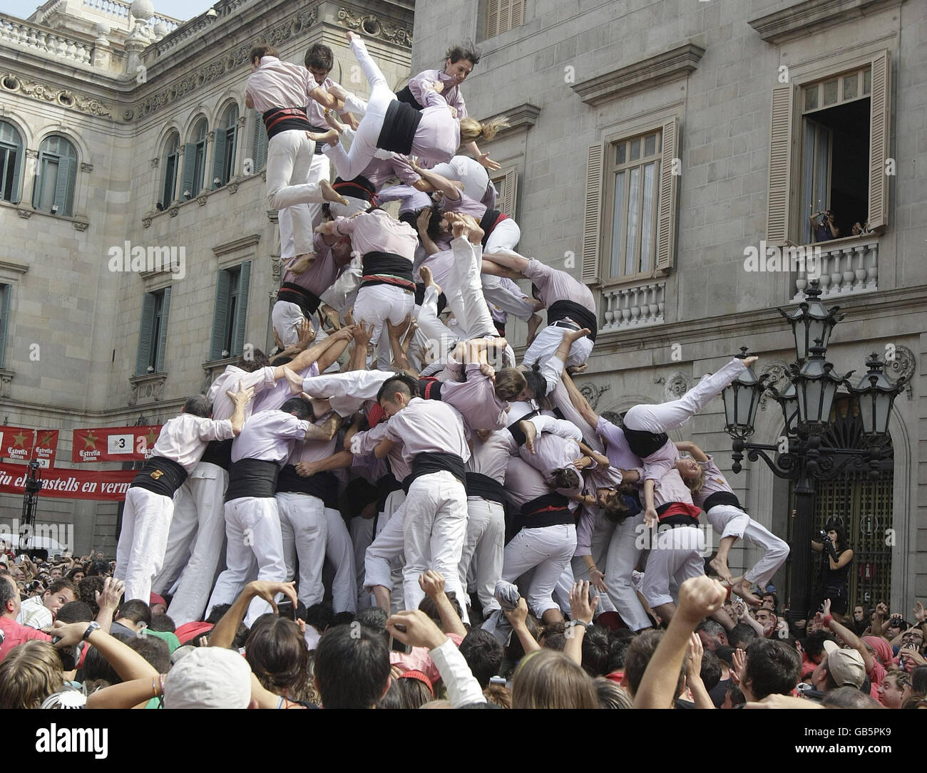 Thousands of people gather to watch competitors form a human 'Castell' during the Festival of Our Lady of Mercy in Barcelona, Catalonia. Stock Photo
