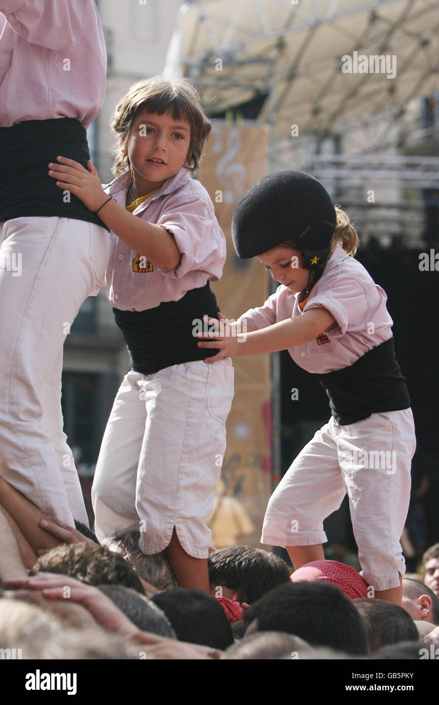 Children prepare to climb to the top of a human 'Castell' during the Festival of Our Lady of Mercy in Barcelona, Catalonia. Stock Photo