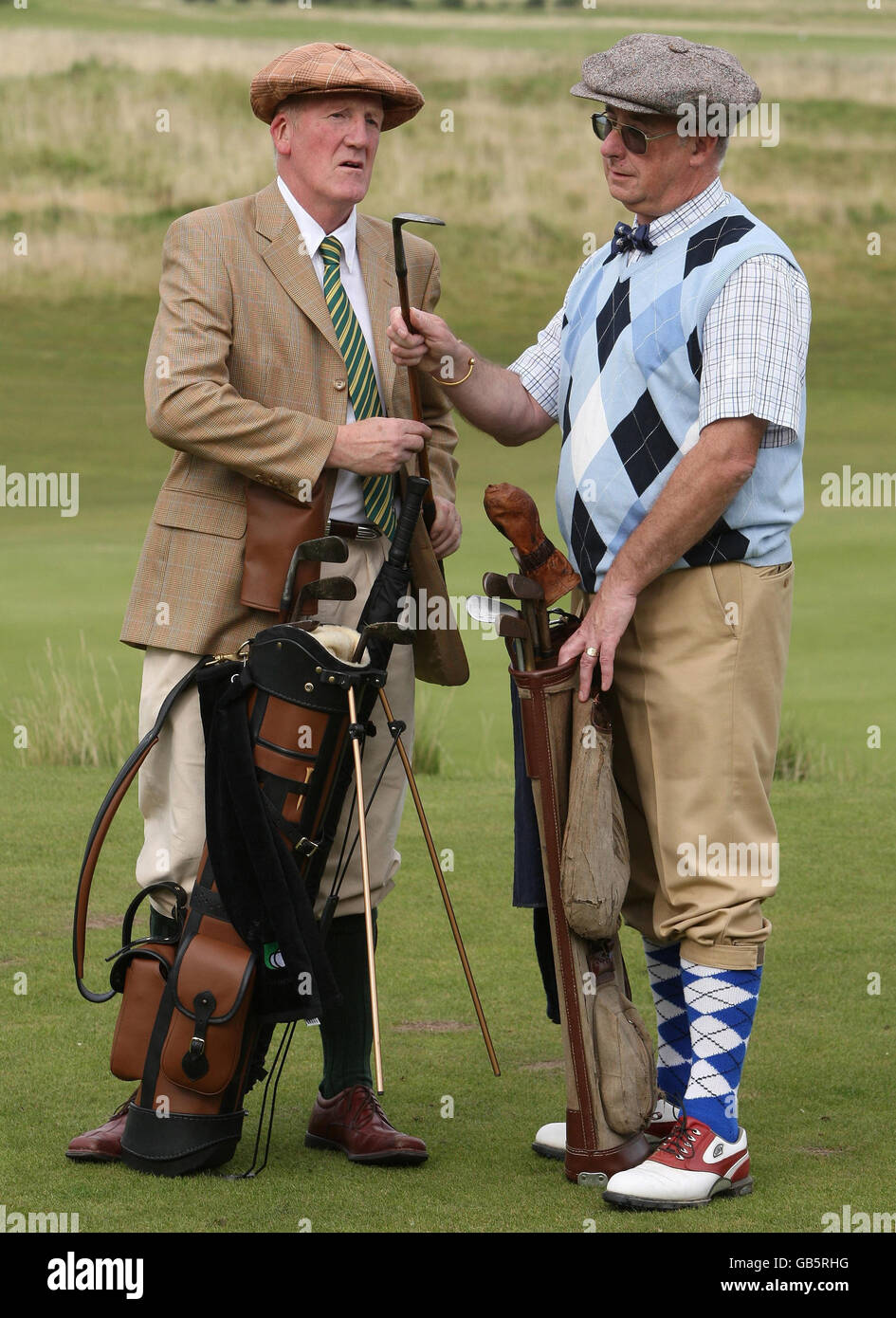 Golfers compare clubs during the World Hickory Open Golf Championship