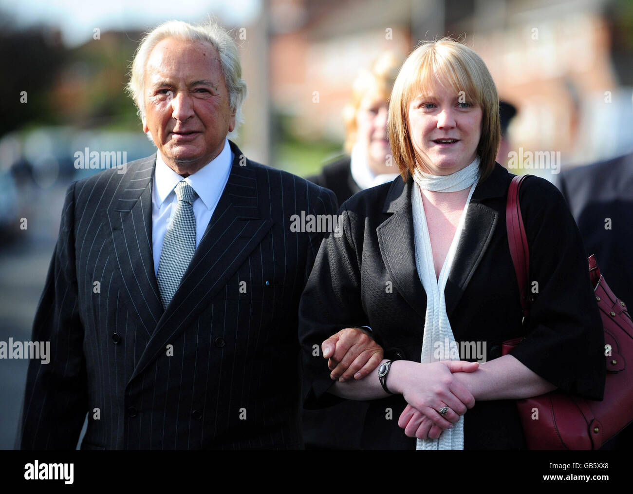 Michael Winner (left), Chairman of the Police Memorial Trust, arrives with Eilisa Broadhurst (right), widow of PC Ian Broadhurst, at a memorial unveiling ceremony in Dib Lane in Leeds. Stock Photo