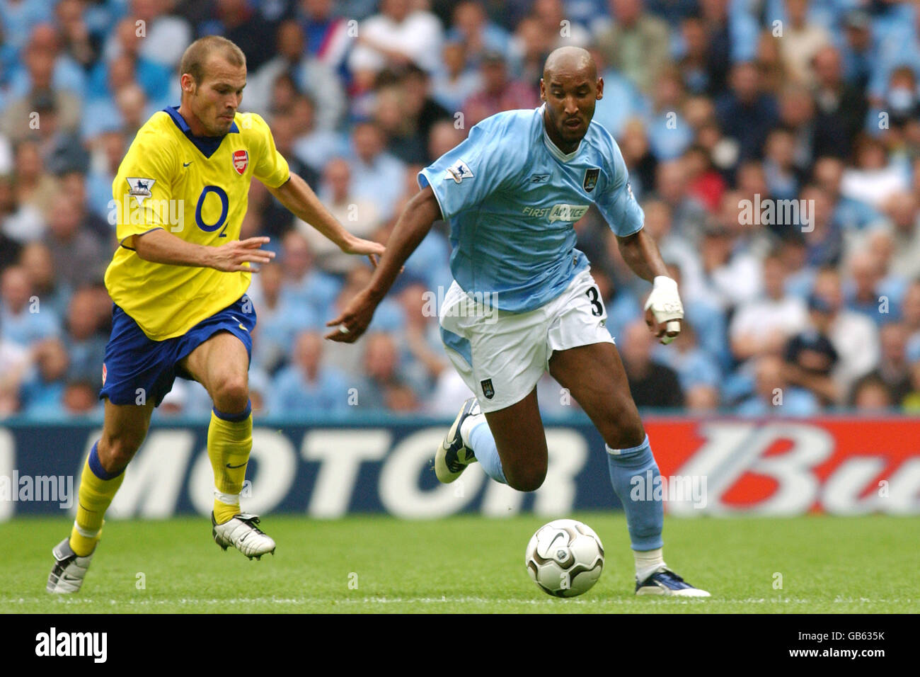 Arsenal's Nicolas Anelka evades a tackle from West Ham United's