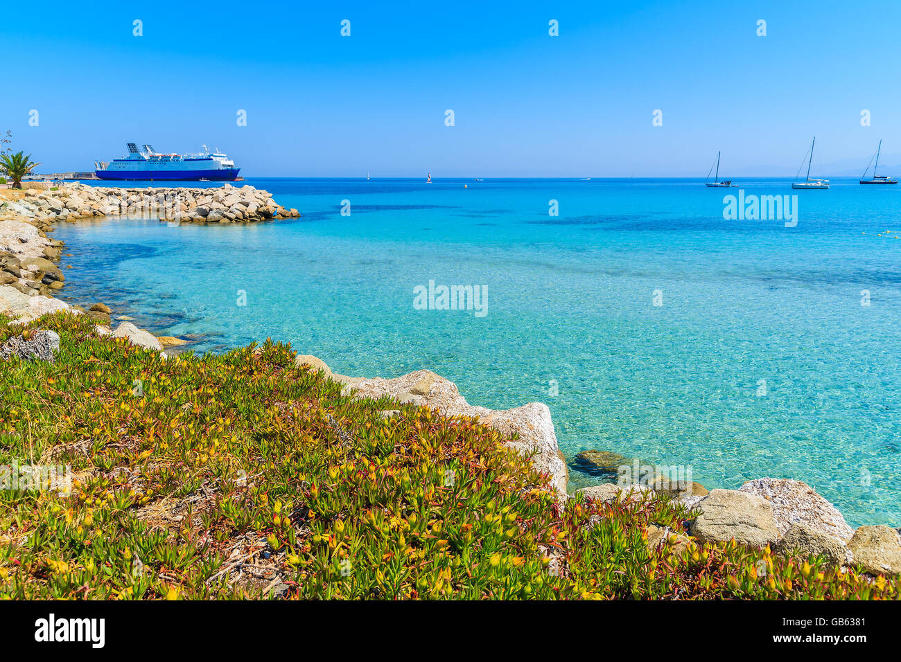 Azure sea bay in Ile Rousse coastal town, Corsica island, France Stock Photo