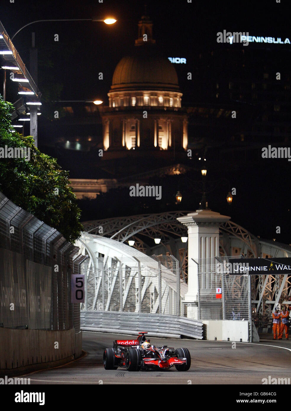 McLaren Mercedes' Lewis Hamilton drives over the Anderson Bridge during a practice session at the Marina Bay Circuit Park in Singapore. Stock Photo