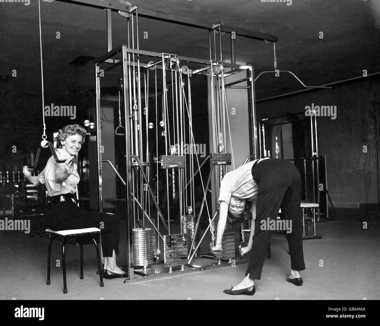 Group of women poses at exercise machine in gym - stock photo 1954900