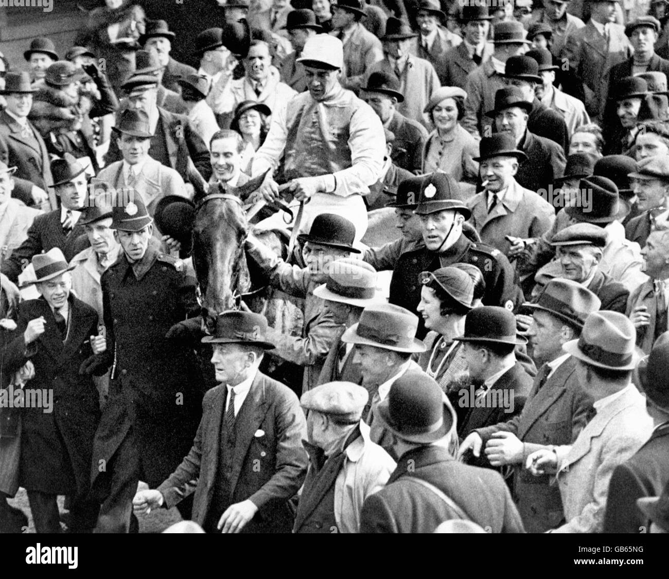 Grand National winner Reynoldstown, Fulke Walwyn up, is led in by owner