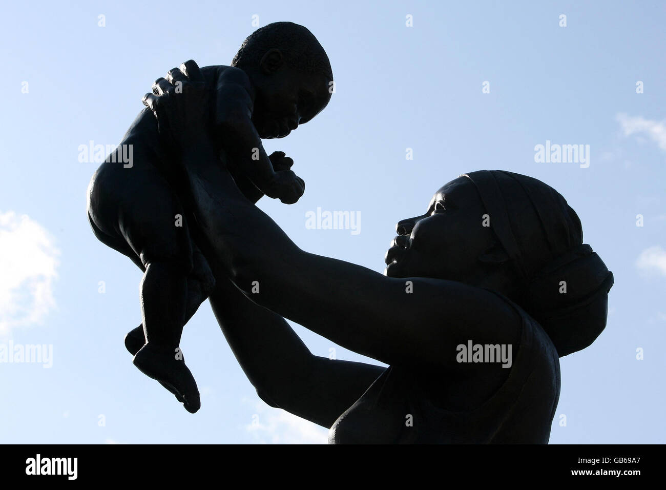 The Bronze Woman monument, a three-metre (10ft) high sculpture of an unnamed Caribbean woman holding her child high above her head and looking into his eyes, created by Aleix Barbat, is unveiled in Stockwell Memorial Garden in south London and becomes the first public statue of a black woman in England. It was inspired by a poem called Bronze Woman, written 30 years ago by Cecile Nobrega, a poet born in Guyana in 1919, who has lived in Stockwell for 30 years. Stock Photo