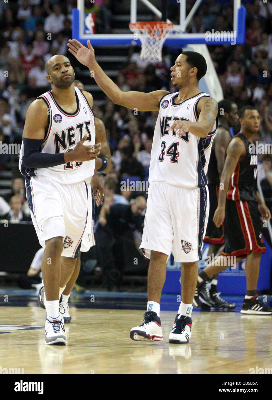 New Jersey Net's Vince Carter celebrates scoring with team mate Devin