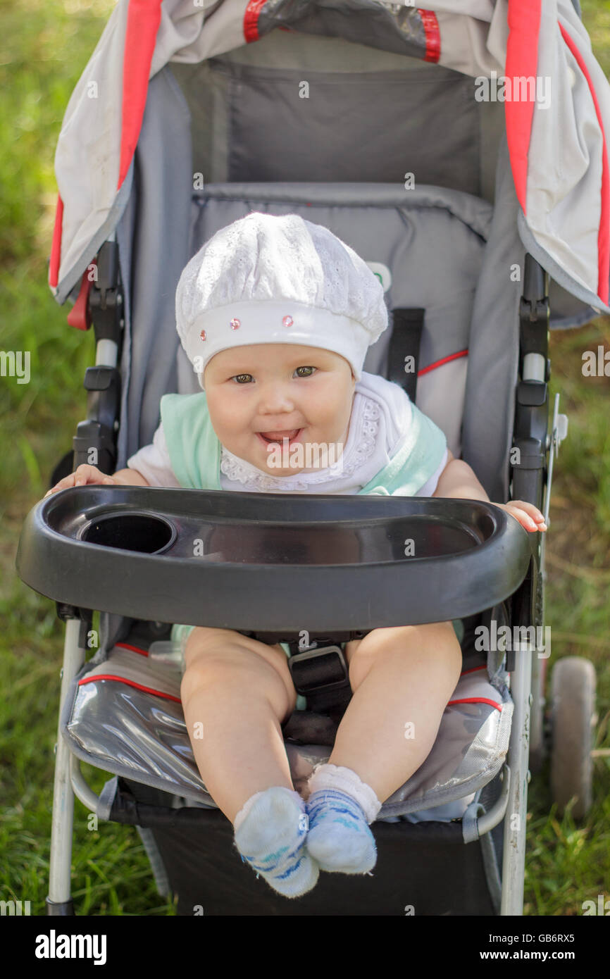 little girl sitting in a baby carriage Stock Photo - Alamy