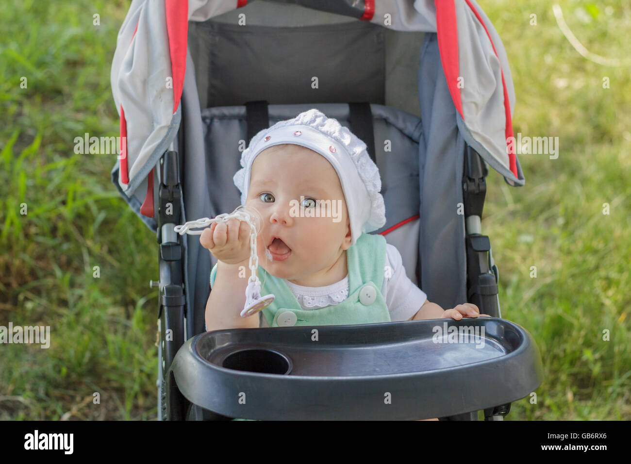 little girl sitting in a baby carriage Stock Photo - Alamy