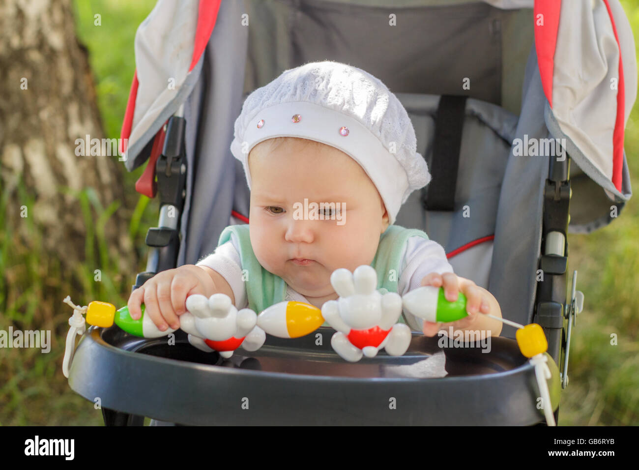 little girl sitting in a baby carriage Stock Photo - Alamy