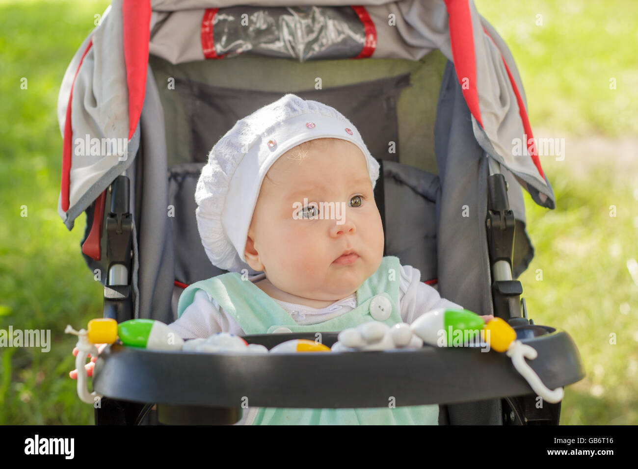 little girl sitting in a baby carriage Stock Photo - Alamy