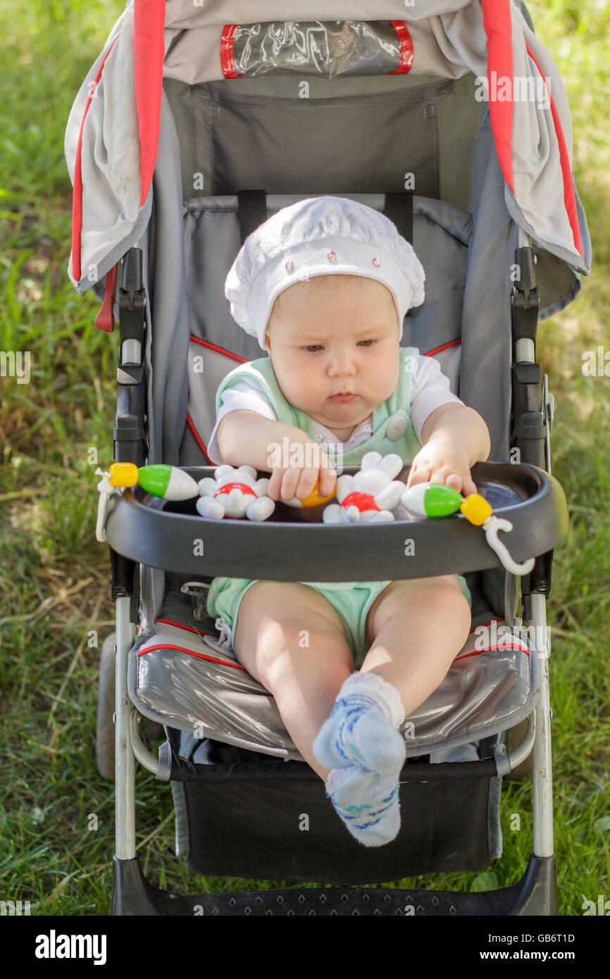 little girl sitting in a baby carriage Stock Photo - Alamy