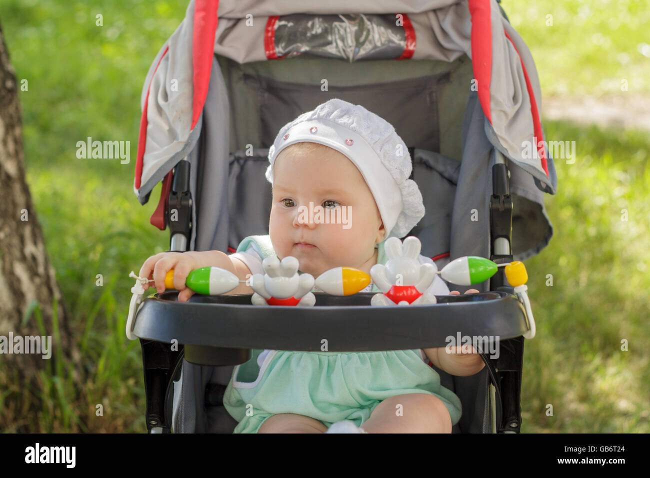 little girl sitting in a baby carriage Stock Photo - Alamy