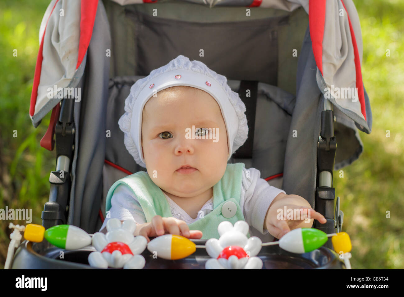 little girl sitting in a baby carriage Stock Photo - Alamy
