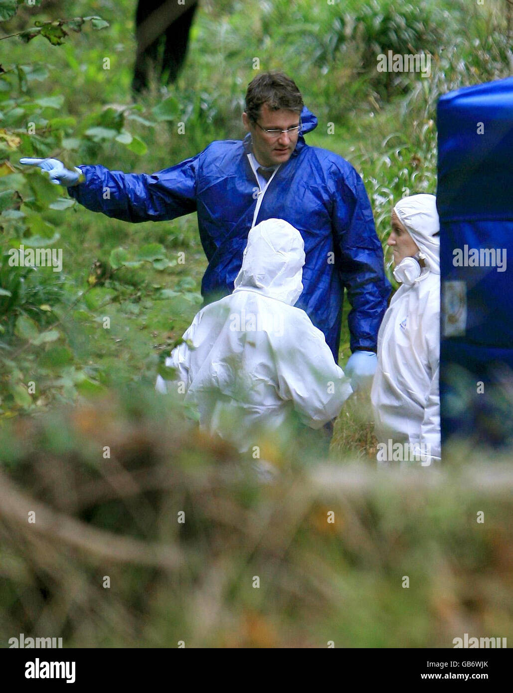 DCI Adam Hibbert with forensic officers at the scene in Hastings, East Sussex, where a female skull was found. Stock Photo